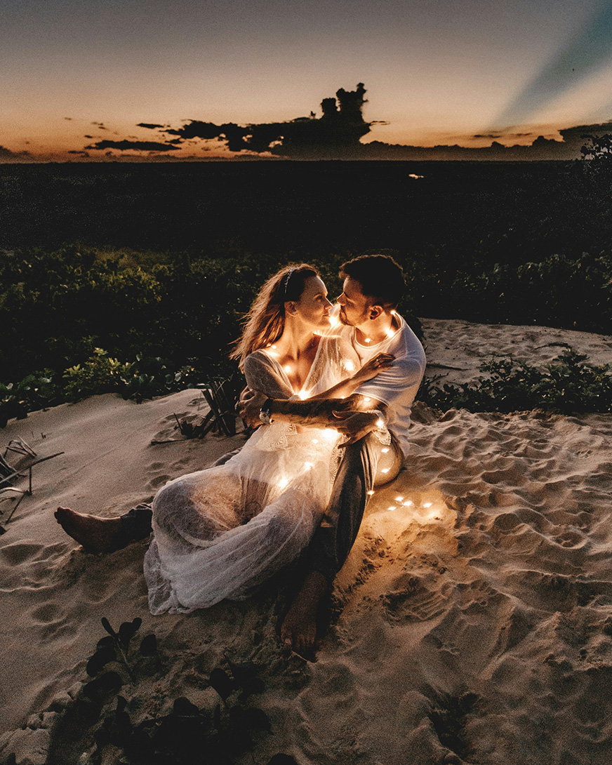 Couple by the beach, waves washing onto shore